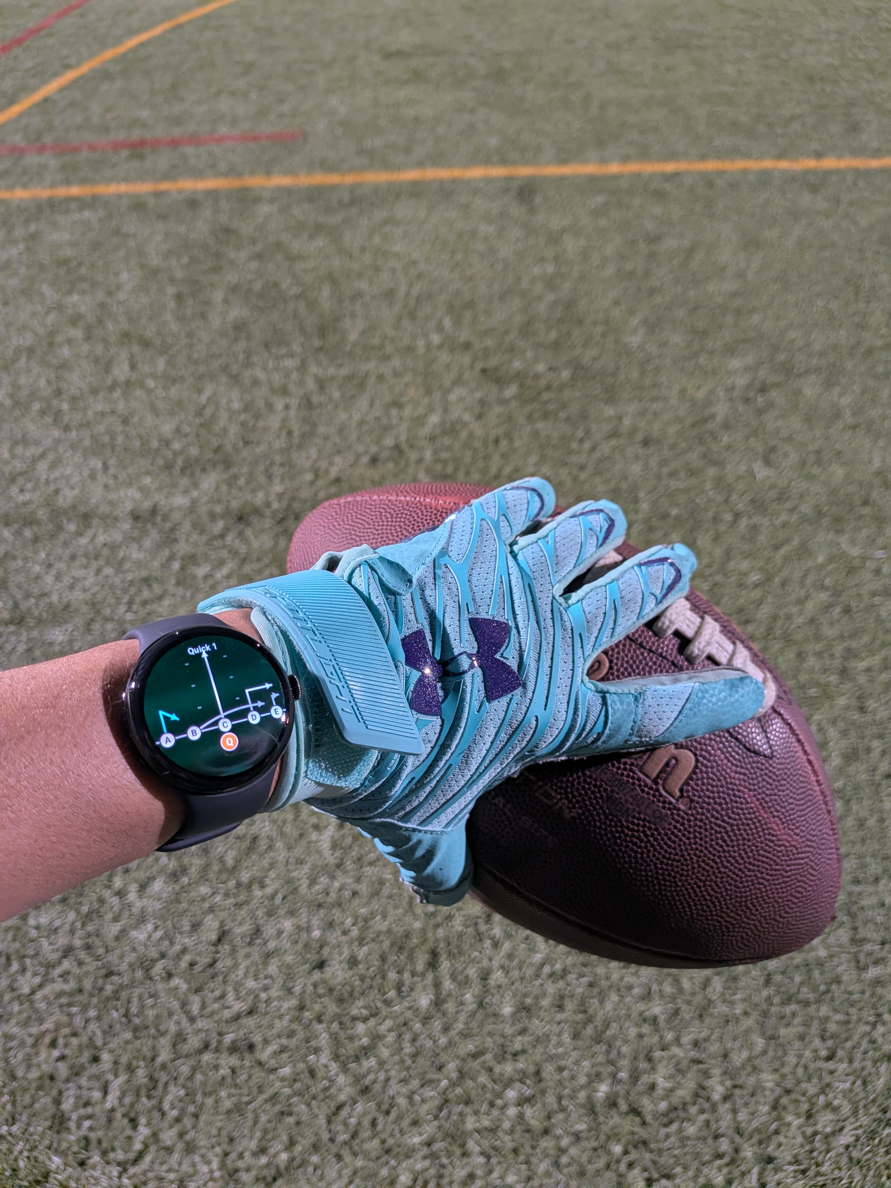 HuddleWrist — Google Pixel Watch displaying a football play diagram next to a gloved hand holding a football